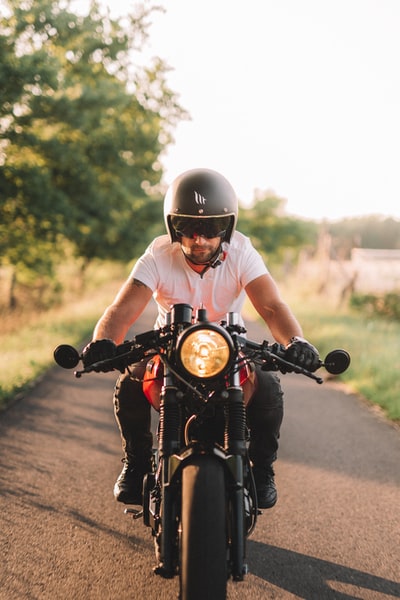 White man ride a motorcycle on the road during the day
